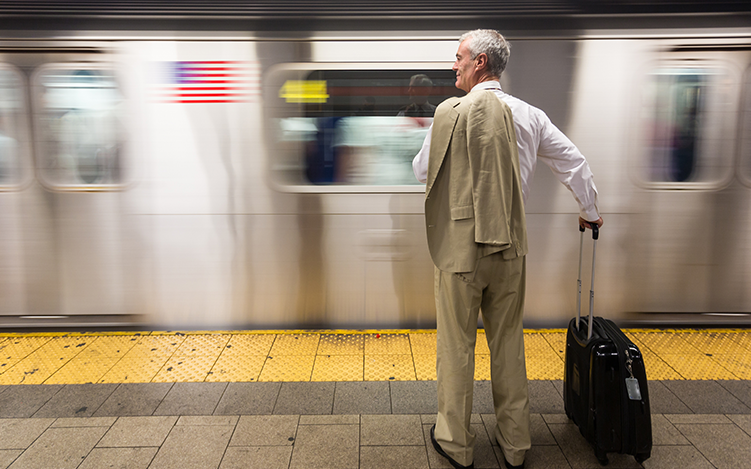 Man looking at moving subway